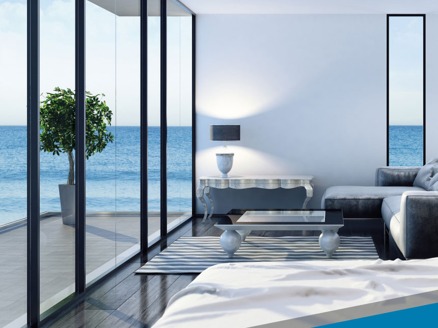 Oceanfront residence interior with floor-to-ceiling glass, furniture protected from UV fade